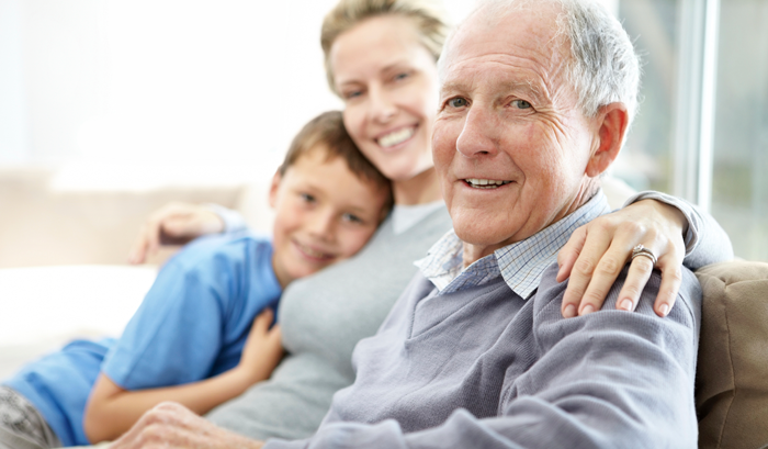 elderly man surrounded by happy family