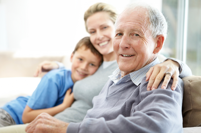 elderly man surrounded by happy family